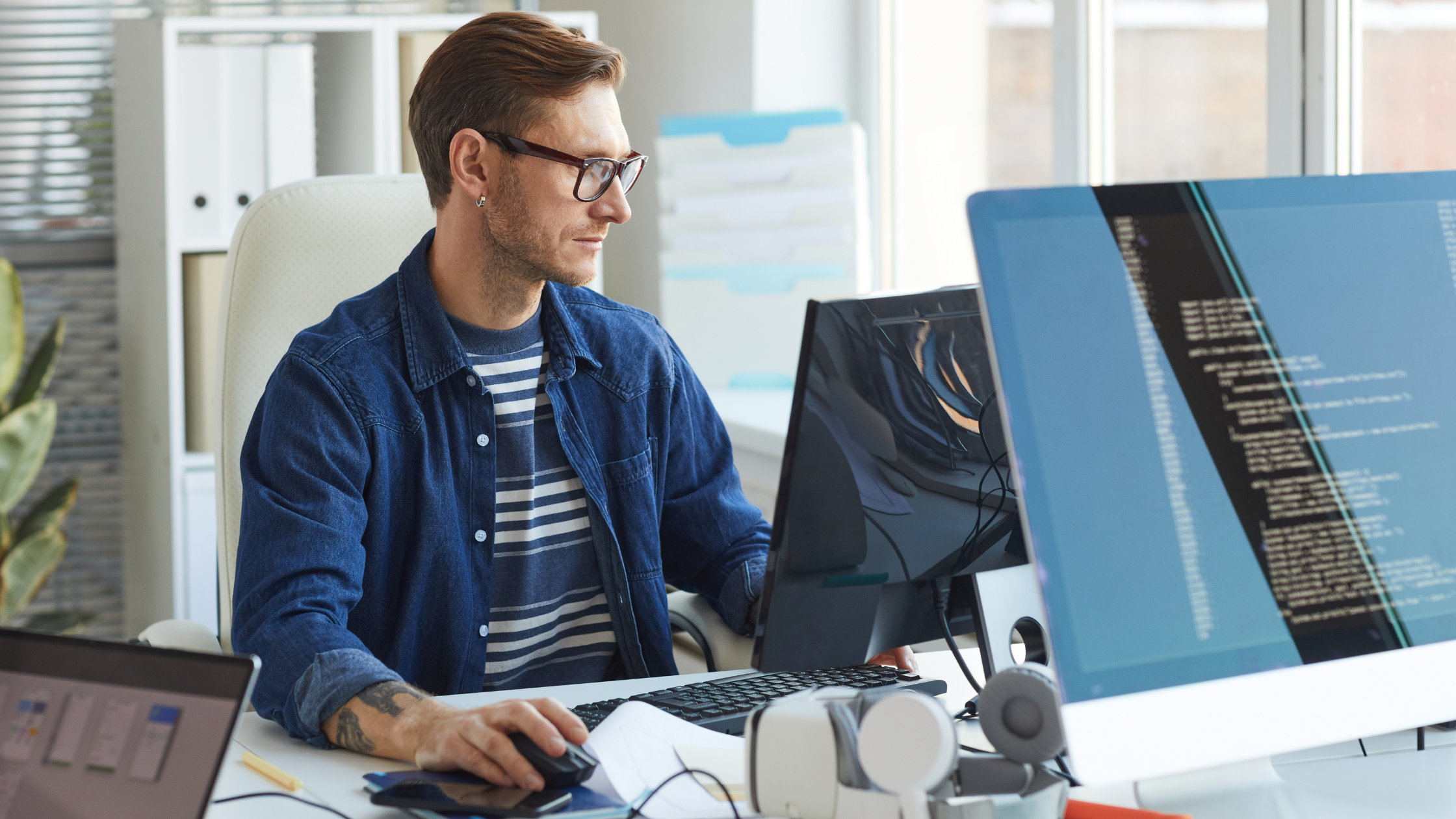 A man sitting on a chair and working on a web development project